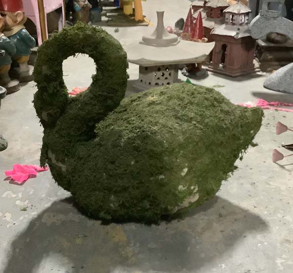 Swan full size covered in moss