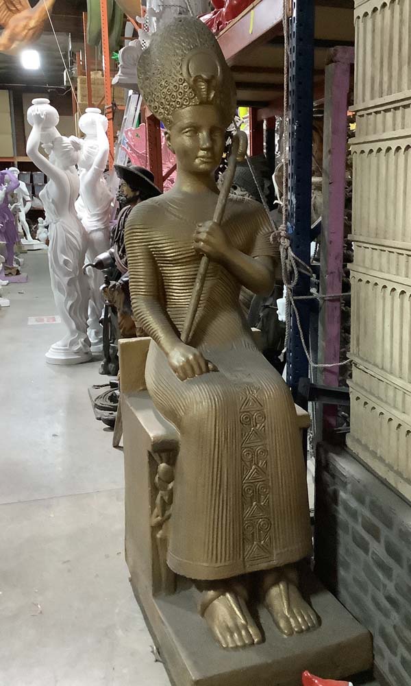 Egyptian statue sitting holding cane